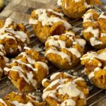 High-protein pumpkin French toast cups topped with creamy date yogurt drizzle, cozy on a fall morning table.