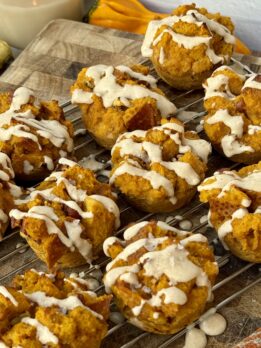 High-protein pumpkin French toast cups topped with creamy date yogurt drizzle, cozy on a fall morning table.
