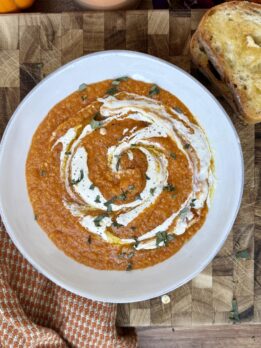 Creamy red lentil tomato soup in a bowl topped with herbs — cozy, high-protein, and perfect for an easy weeknight dinner.