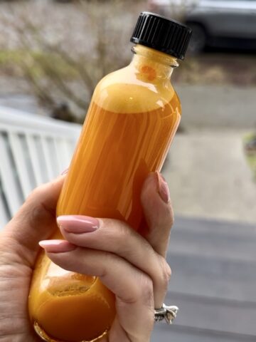 Anti-inflammatory turmeric glow shots made with fresh turmeric, ginger, pineapple, carrots, and lemon