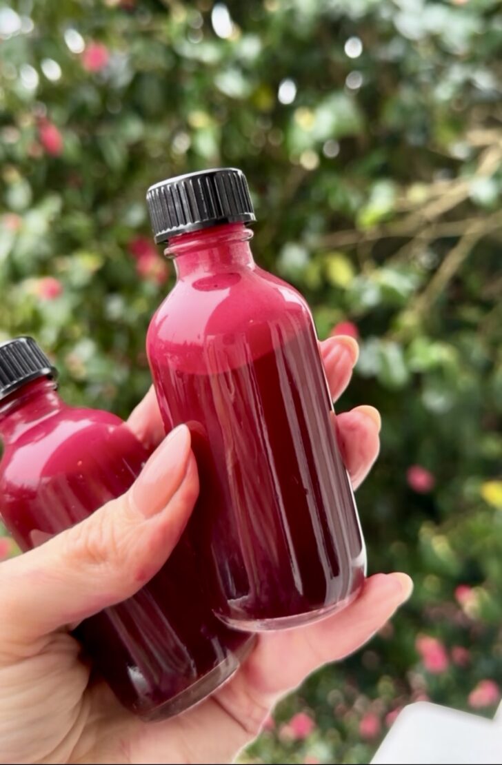 Beet ginger juice shots in clear glass bottles, rich in nitrates and antioxidants for athletic performance.