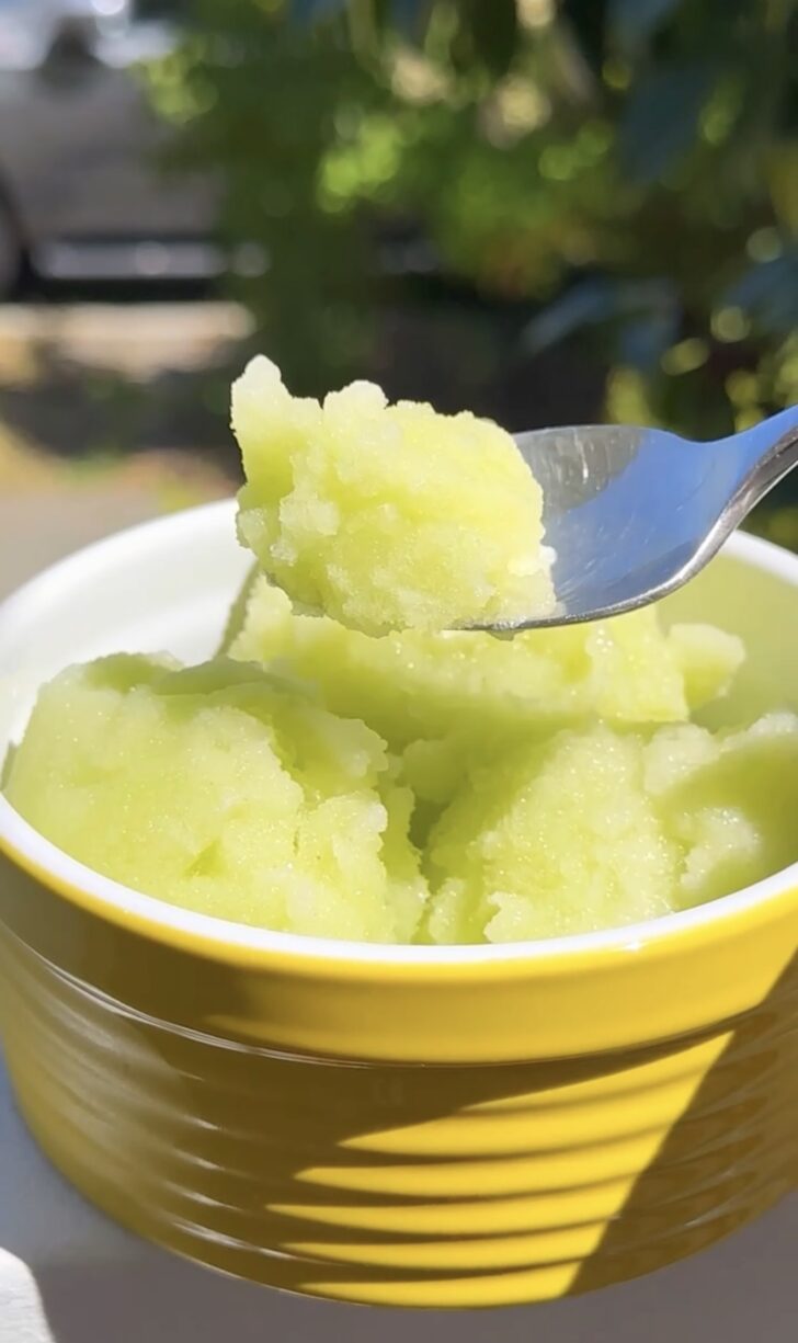 Ginger honeydew melon sorbet in a yellow bowl with spoon, a refreshing healthy green St. Patrick’s Day dessert.