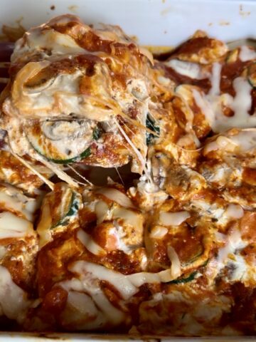 High-protein eggplant lasagna baked with layers of sliced eggplant, creamy ricotta and tofu filling, marinara sauce, melted mozzarella cheese, zucchini, mushrooms, and carrots. Cozy vegetarian comfort food recipe perfect for healthy weeknight dinners and meal prep.