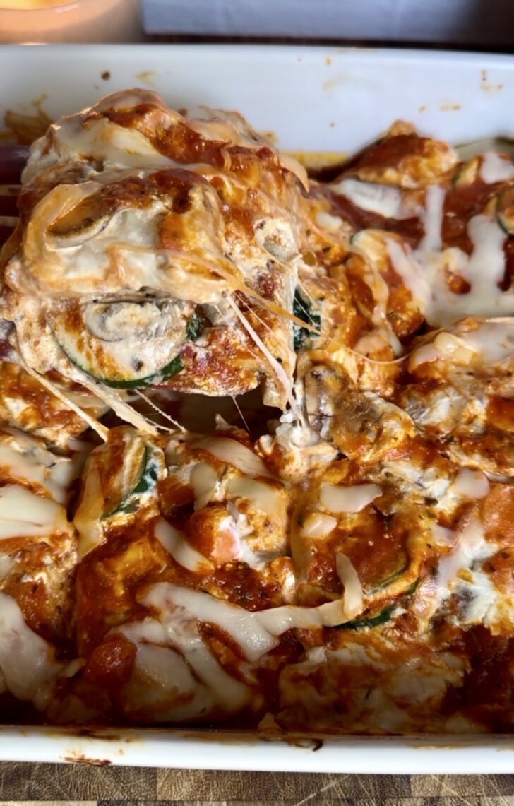High-protein eggplant lasagna baked with layers of sliced eggplant, creamy ricotta and tofu filling, marinara sauce, melted mozzarella cheese, zucchini, mushrooms, and carrots. Cozy vegetarian comfort food recipe perfect for healthy weeknight dinners and meal prep.