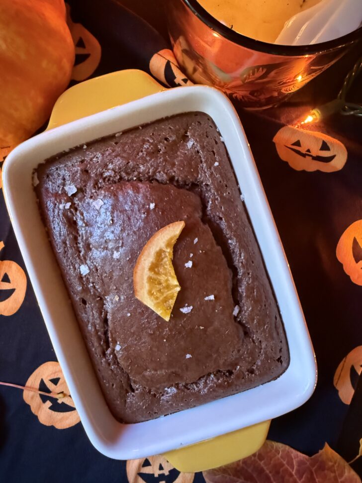Black Flame Brownie Baked Oats with chocolate protein, candied orange and flaky sea salt for a Hocus Pocus-inspired Halloween breakfast.